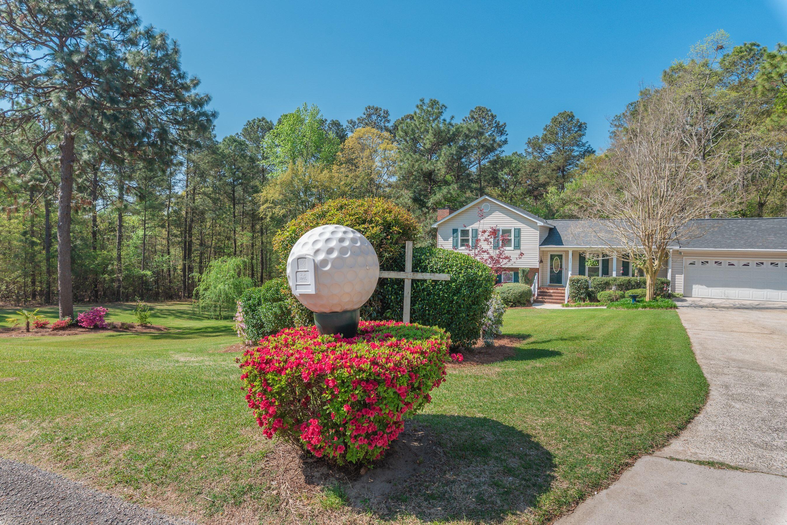 1117 Ridgemont Drive Aiken, SC 29803 - Photo 4 of 49 a front view of a house with garden and swimming pool
