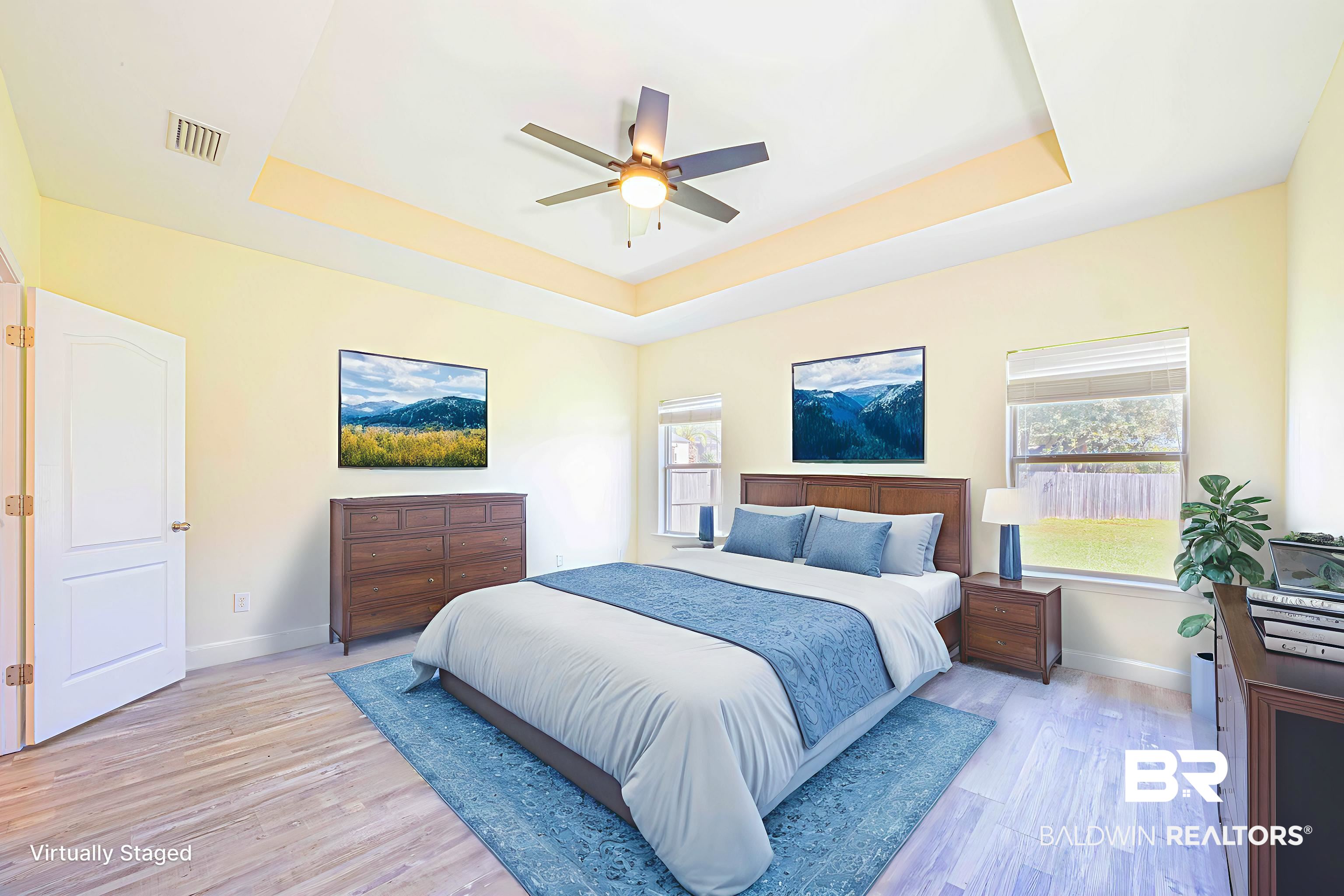 25234 Fairfax Road Daphne, AL 36526 - Photo 23 of 45 Bedroom featuring a raised ceiling, multiple windows, light wood-style floors, and a ceiling fan
