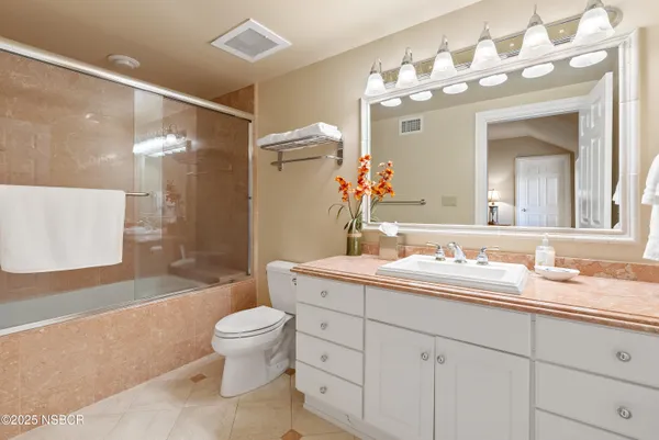 a bedroom with a bed and a chair