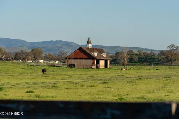 an aerial view of a house with a yard and lake view