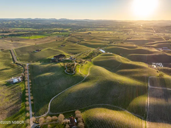 a view of a house with a yard and lake view