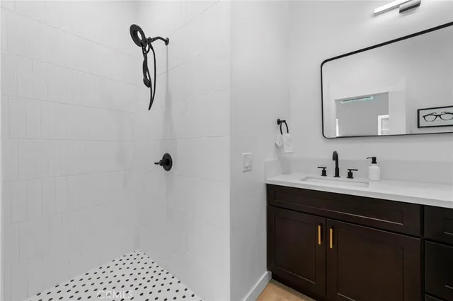 a bathroom with a sink a mirror and shower