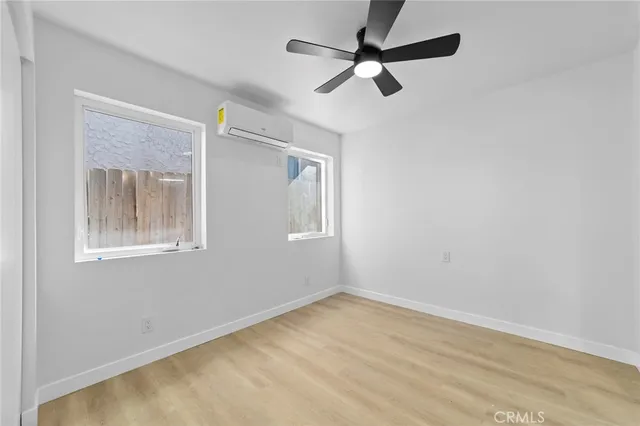 a view of an empty room and kitchen view