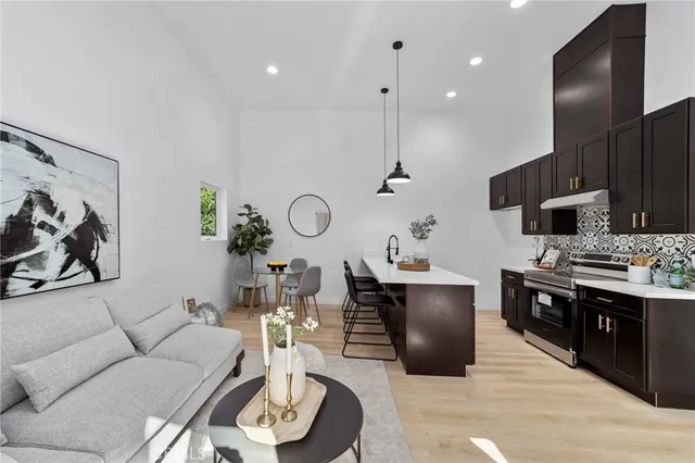 a living room with furniture kitchen and a table