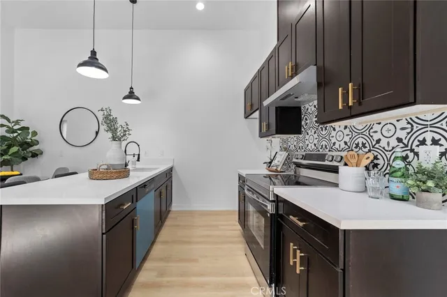 a kitchen with sink cabinets and stove top oven
