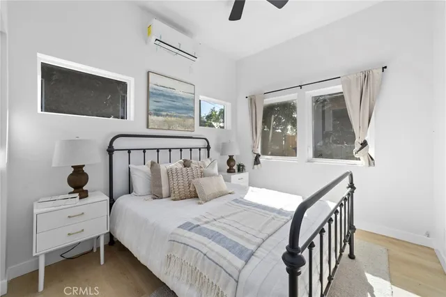 a bedroom with a bed and a window