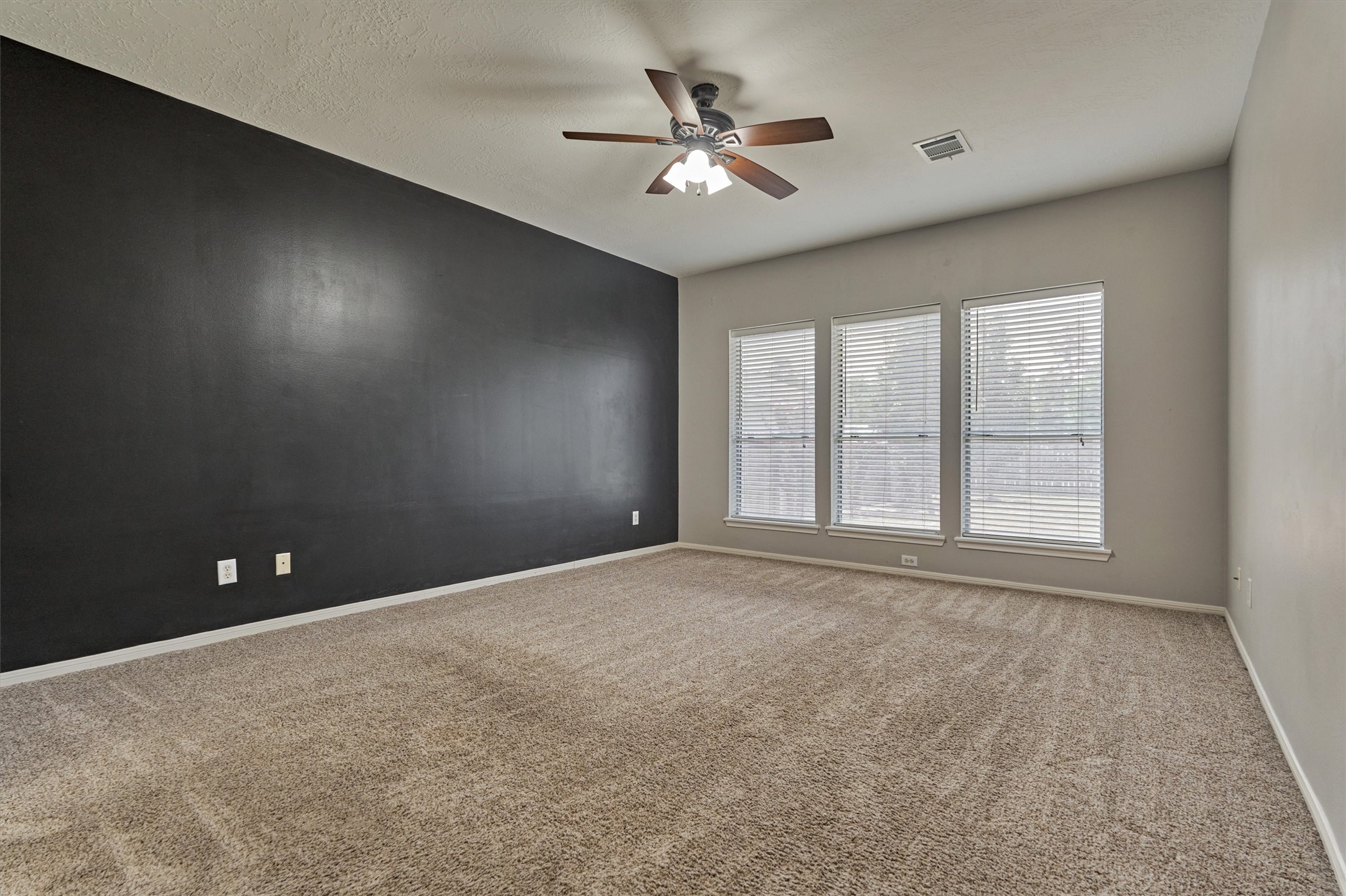 1618 Calmar Drive Spring, TX 77386 - Photo 14 of 30 an empty room with chandelier fan and windows