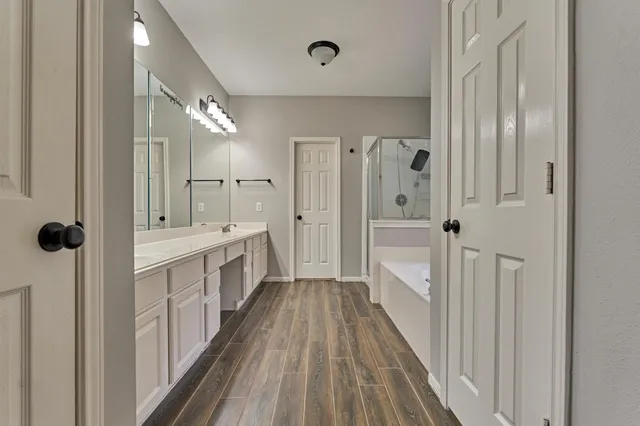 a bathroom with a double vanity sink and mirror