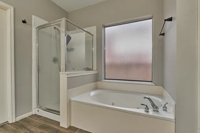 a bathroom with a tub and a shower