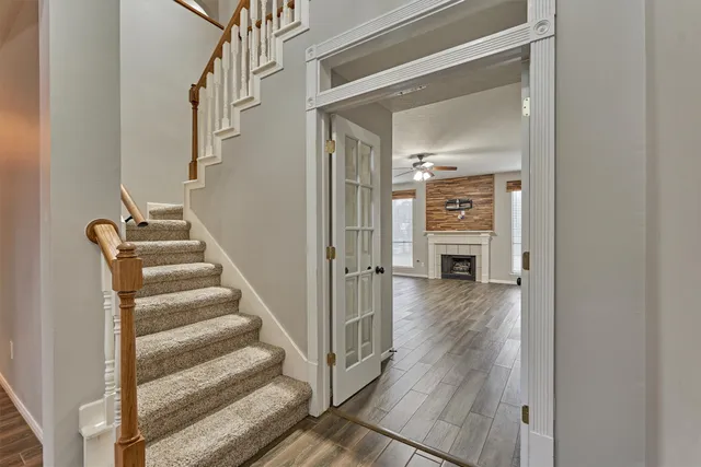 a view of a hallway with wooden floor and entryway