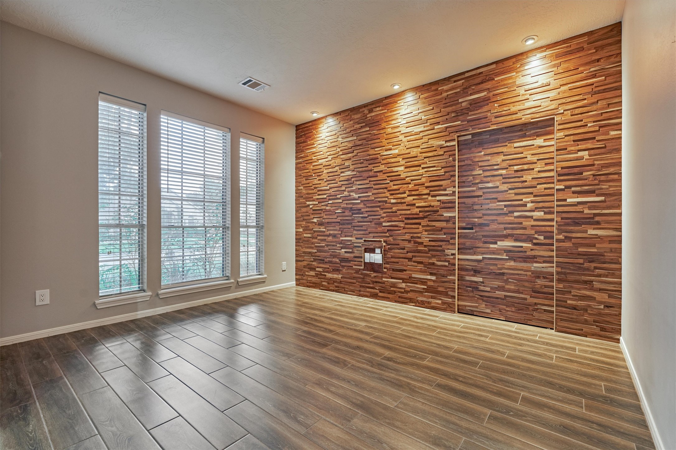 1618 Calmar Drive Spring, TX 77386 - Photo 5 of 30 a view of an empty room with wooden floor and a window