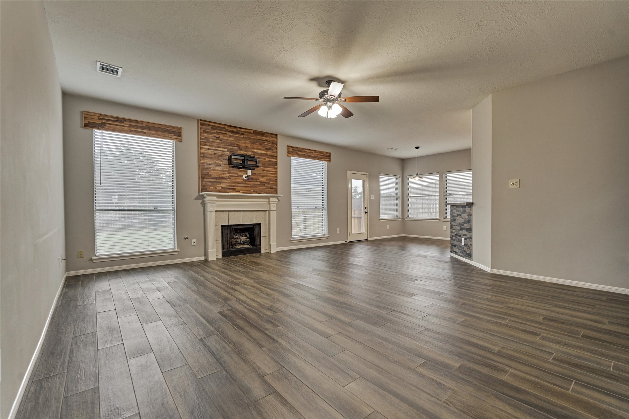 1618 Calmar Drive Spring, TX 77386 - Photo 9 of 30 a view of a livingroom with wooden floor fireplace and a window