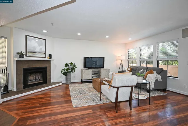 a living room with furniture a window and a fireplace