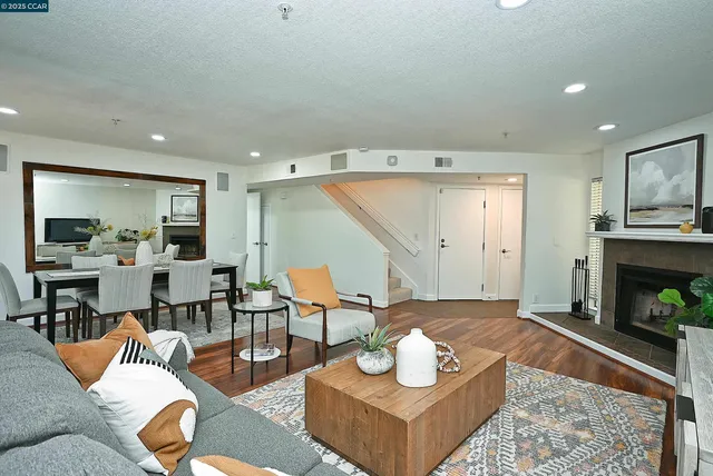 a living room with furniture and a fireplace