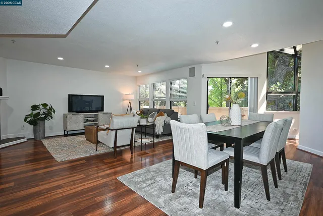 a view of a dining room with furniture window and wooden floor