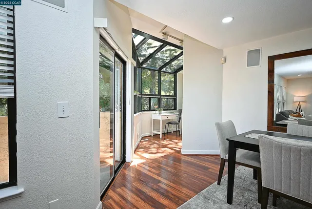a workspace with wooden floor and a window