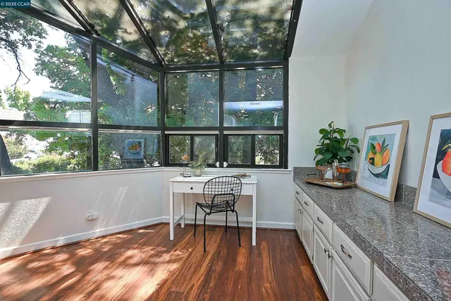 a view of a house with backyard and sitting area
