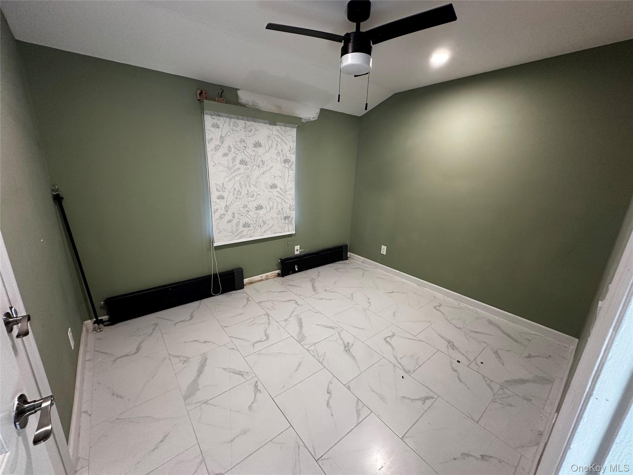 89-32 Pontiac Street Queens, NY 11427 - Photo 6 of 9 a bedroom with a large bed and a chandelier