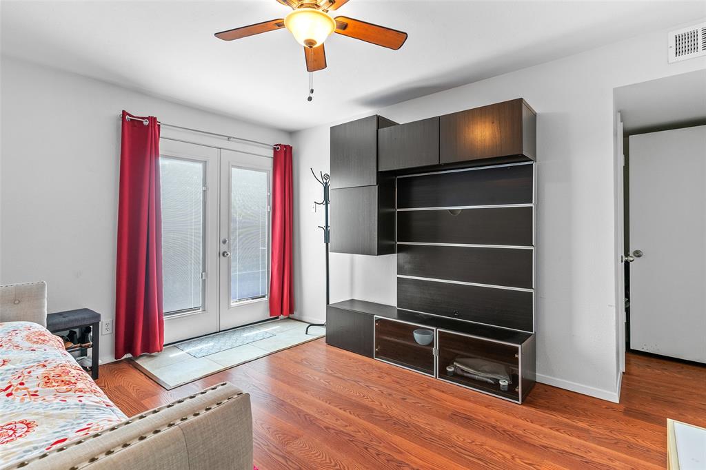 5904 Sandhurst Lane, Unit 147 Dallas, TX 75206 - Photo 11 of 19 a bed room with a bed and a television