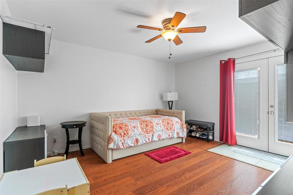 5904 Sandhurst Lane, Unit 147 Dallas, TX 75206 - Photo 12 of 19 a bedroom with a bed and a chandelier