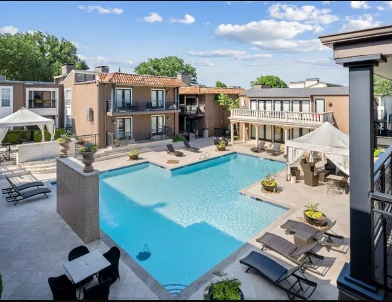 5904 Sandhurst Lane, Unit 147 Dallas, TX 75206 - Photo 18 of 19 a view of a house with swimming pool and furniture