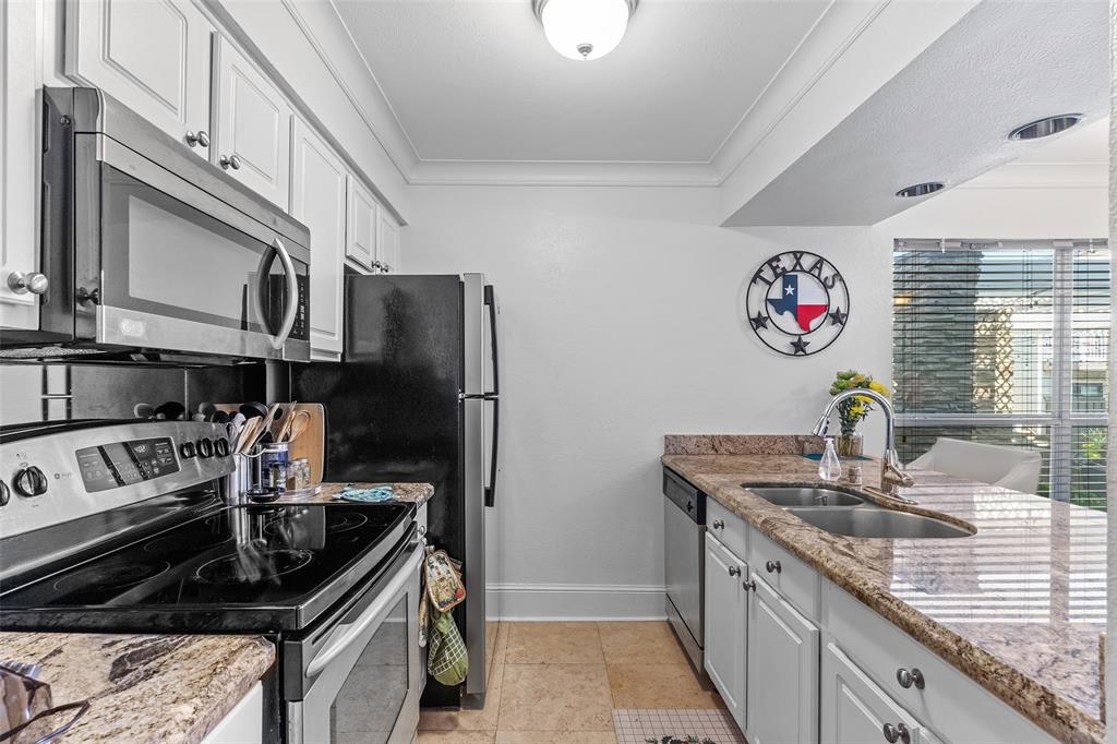 5904 Sandhurst Lane, Unit 147 Dallas, TX 75206 - Photo 4 of 19 a kitchen with stainless steel appliances granite countertop a sink stove and refrigerator