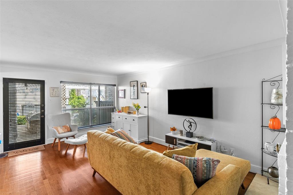 5904 Sandhurst Lane, Unit 147 Dallas, TX 75206 - Photo 7 of 19 a living room with furniture and a flat screen tv