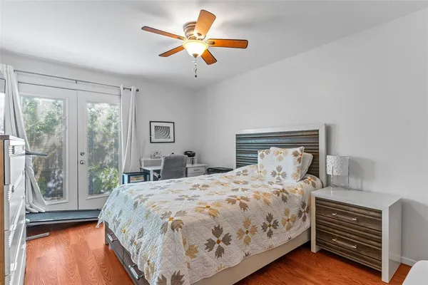 a bedroom with a large bed and a large window