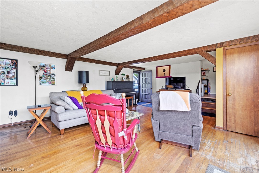 324 Erie Road Vermilion, OH 44089 - Photo 23 of 36 Living room featuring wood-type flooring and beam ceiling