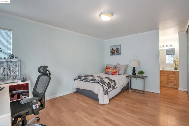 a bedroom with a bed a table and chair