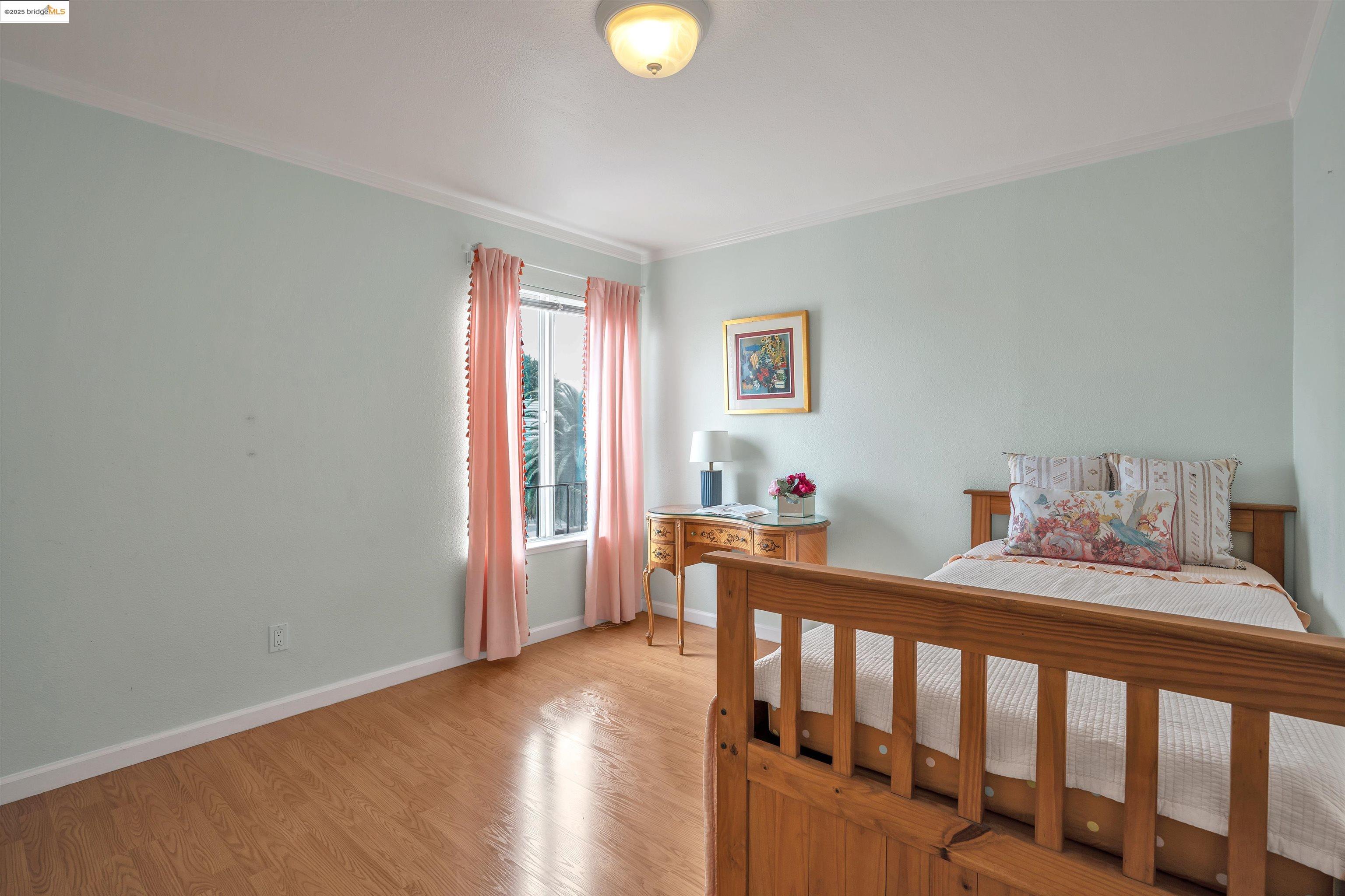 15 Mateo Avenue, Unit 7 Millbrae, CA 94030 - Photo 16 of 25 a bedroom with furniture and wooden floor