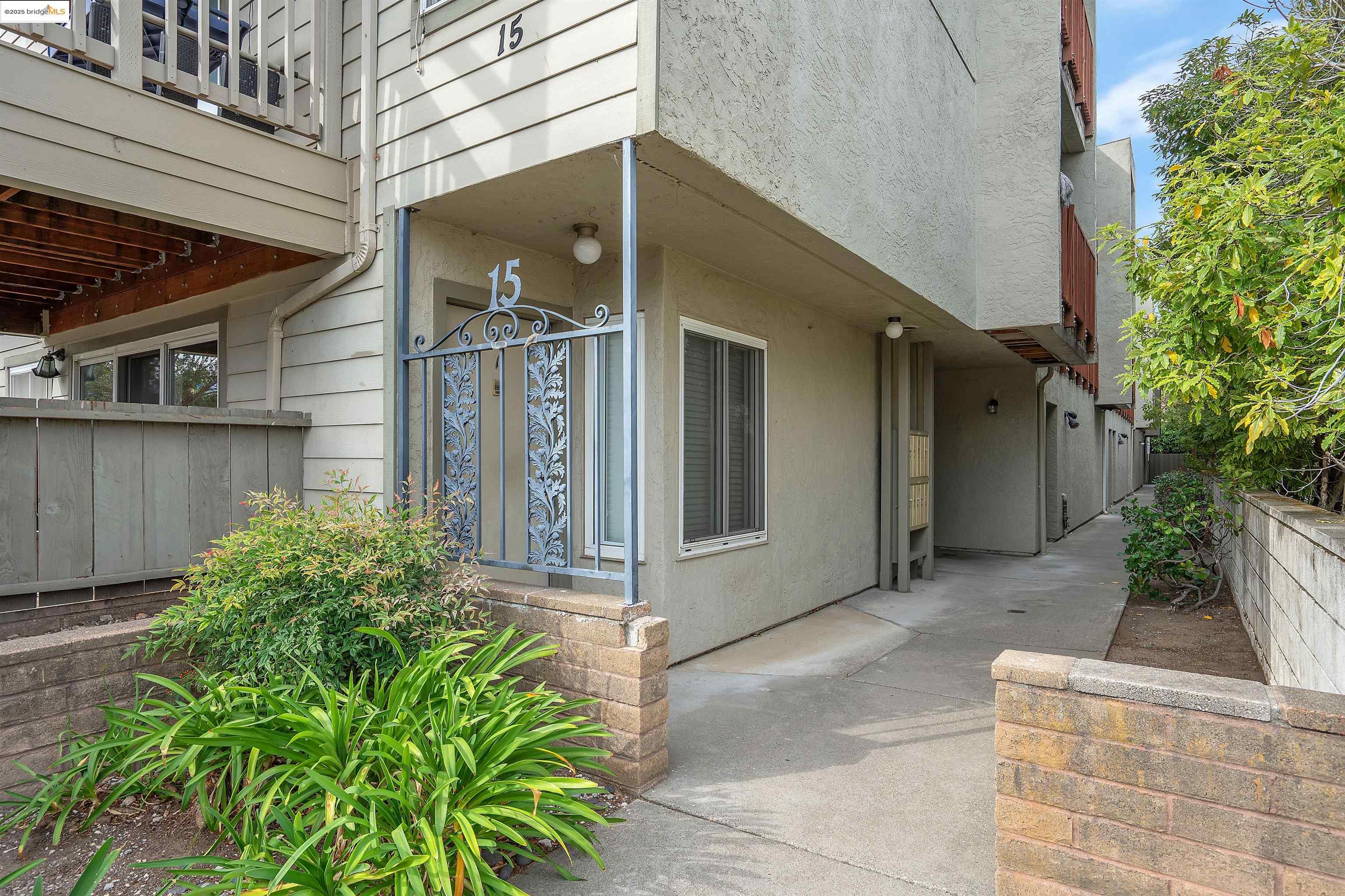 15 Mateo Avenue, Unit 7 Millbrae, CA 94030 - Photo 3 of 25 a view of a house with a small yard and plants
