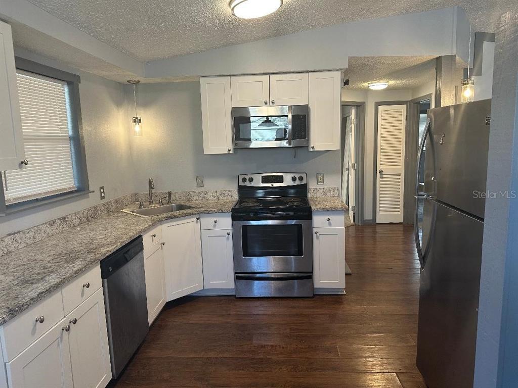 4048 Pecos Drive New Port Richey, FL 34653 - Photo 6 of 15 a kitchen with a refrigerator and a sink