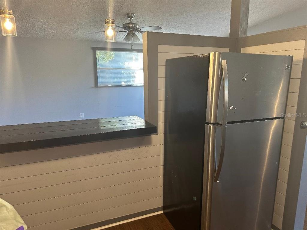 4048 Pecos Drive New Port Richey, FL 34653 - Photo 8 of 15 a view of a refrigerator in kitchen and wooden floor