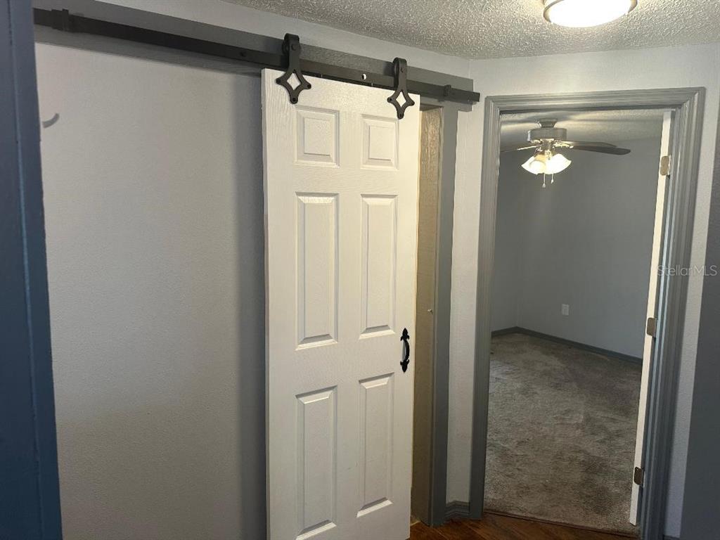 4048 Pecos Drive New Port Richey, FL 34653 - Photo 9 of 15 a bathroom with a glass shower door