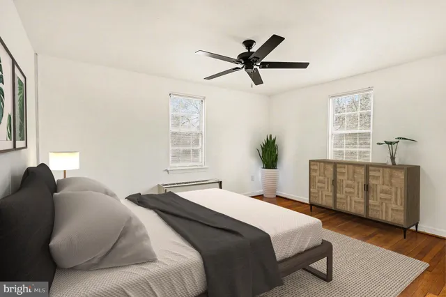 a bedroom with a bed dresser and a window