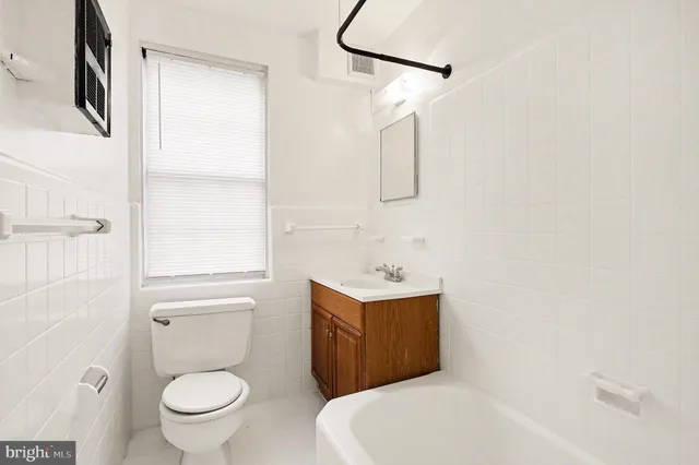 a white toilet sitting next to a bathroom sink