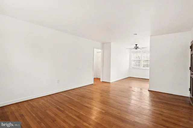 an empty room with wooden floor