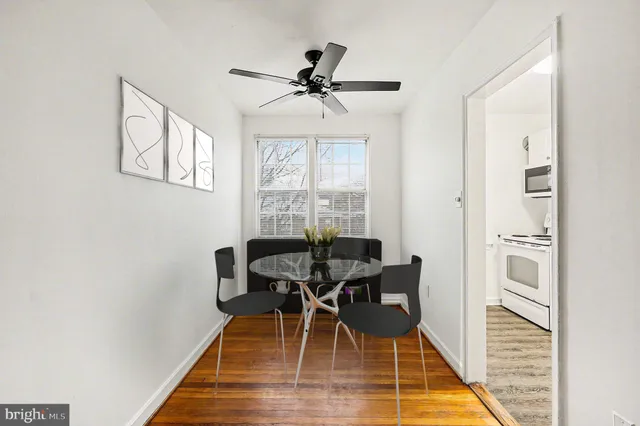 a dining room with furniture window and wooden floor