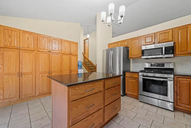 a kitchen with stainless steel appliances granite countertop a refrigerator sink and cabinets