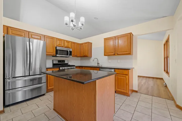 an empty room with windows and ceiling fan