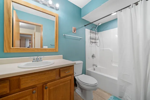 a view of empty room with wooden floor and fireplace