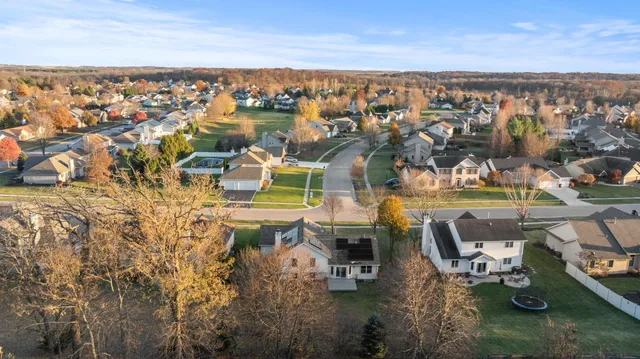 an aerial view of a house with a yard basket ball court and outdoor seating