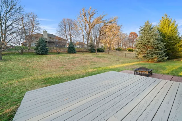 a view of a large house with a yard and large trees