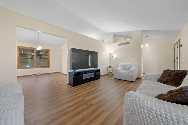 a bedroom with furniture and a flat screen tv