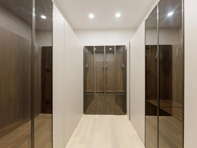 a view of hallway with stainless steel appliances kitchen island granite countertop furniture