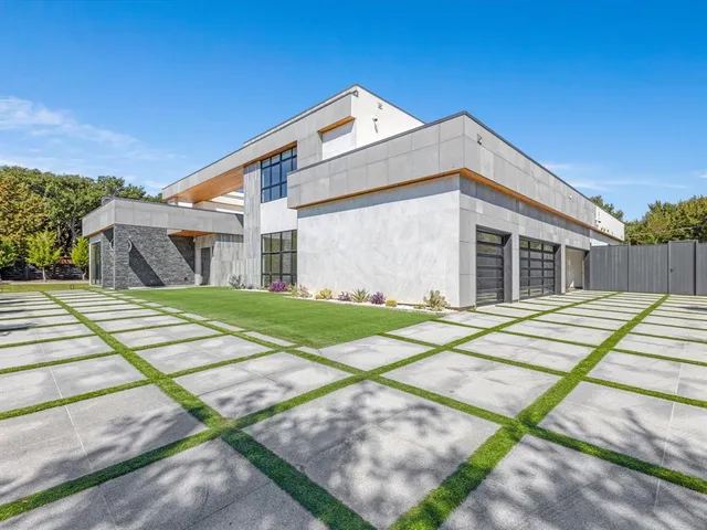 a white house with a small yard and a large window