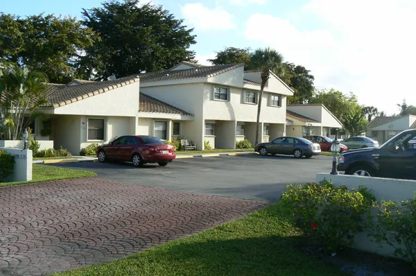 a couple of cars parked in front of a house