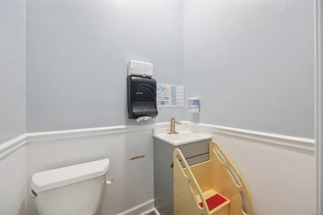 a utility room with sink dryer and washer