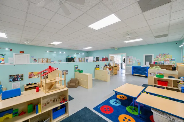 a view of a field with trees in the background